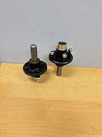 Pair of idler hubs with spindles standing upright