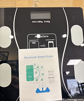 Front view of scale showing display, sensors, instruction graphic