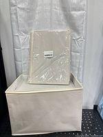 Folded second bin still in plastic on top of assembled bin