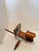 Side view of wooden stereoscope showing hood, slide holder, handle