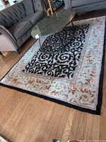Full view of rug under coffee table showing pattern and border