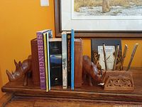 Full arrangement of books, bookends, pen holder with pens and elephant frame