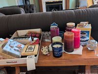 Overall lot on coffee table showing candles, simmer pot, coasters, napkins
