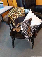 Chair, throw blanket, and pillow arranged together