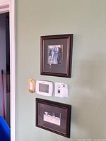 Both framed prints on wall for size context