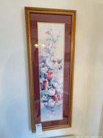 Full view of framed floral print in gold frame with mats