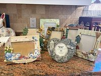 Group shot of seven decorative 3D motif picture frames on countertop