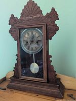 Full front view of Waterbury gingerbread mantel clock on surface