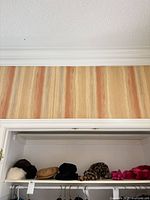 Overview of hats and headband on closet shelf