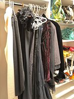 Clothing rack showing multiple dresses, skirts, jackets