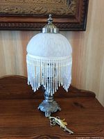 Full view of lamp with beaded shade and key
