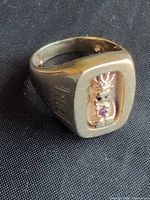 Three-quarter view of ring showing Billiken figure in bezel