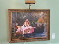 Framed painting on wall with picture light