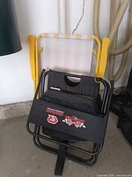 Both chairs folded and leaning against wall