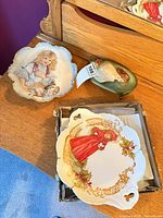 Overview of three hand-painted porcelain items on dresser