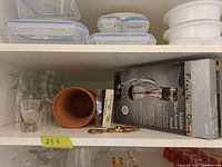 Shelf with wine glasses, boxed aerator set, corkscrew, wine charms, shot glass