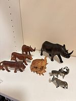 Group view of all wooden and metal animal figurines