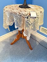 Full view of wood accent table with doily