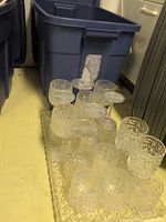 Blue Rubbermaid tote with acrylic tray and textured acrylic glasses