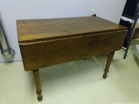 Closed drop-leaf table front view