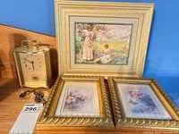 Group shot of mantel clock, keys, large framed print and two small framed prints