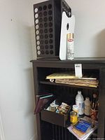 Full lot showing rack, palette, shelves with paints, brushes, tack cloth