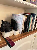 Shelf view showing both horse bookends, books and bookmarks