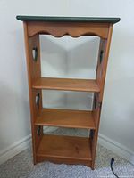 front view of pine bookshelf with heart cutouts and three shelves
