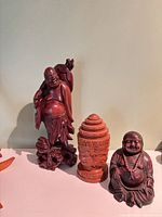 Three Buddha-themed statues grouped together