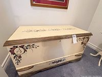 Full view of chest front showing floral design and latch