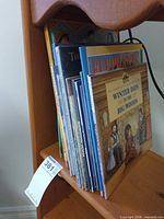 Stack of children’s books on shelf showing quantity and variety