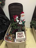 Tote showing contents including greenery, Santa, ornaments