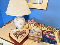 Overall lot showing lamp, heart clock, box and notebooks
