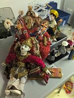 Group view of assorted puppets and dolls on table
