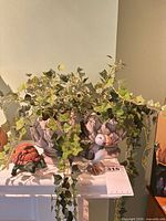 All items grouped: two resin planters with faux ivy, ceramic puffin, ceramic turtle