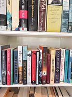 Full shelf view of assorted softcover books