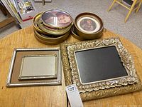 Stack of round frames and two rectangular frames on table