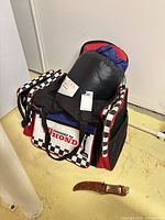 Honda duffle bag with sleeping bag inside and carving knife in foreground