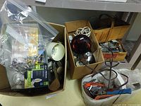 Overview of boxes containing bulbs, junction boxes, wrench and hardware