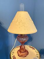 Full view of pink pressed glass hurricane lamp with shade and chimney
