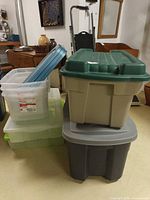 Stack of various totes showing green Roughneck on beige base atop grey tote, plus clear underbed and Latchables units