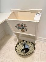 Magazine rack front view with floral motif and ceiling light inside