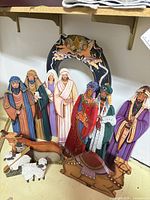 All pieces arranged: backdrop, human figures, animals