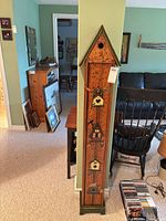 Full view of tall skinny painted wooden cabinet