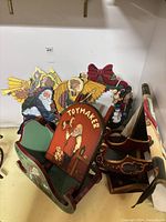 Group shot of painted wooden sleighs, plaque, wreath and cutout figures