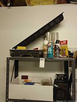 Overall view on shelving showing trays, sprays, hardware box and heater