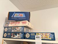 Stack of puzzle boxes and sorting tray set on shelf