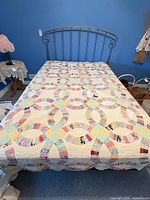 Full top view of handcrafted patchwork quilt on bed