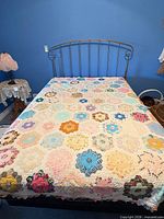 Full view of quilt spread on bed