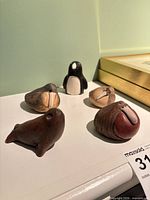 Group view of five resin marine animal figurines on shelf